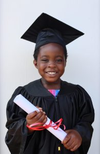 child holding diploma